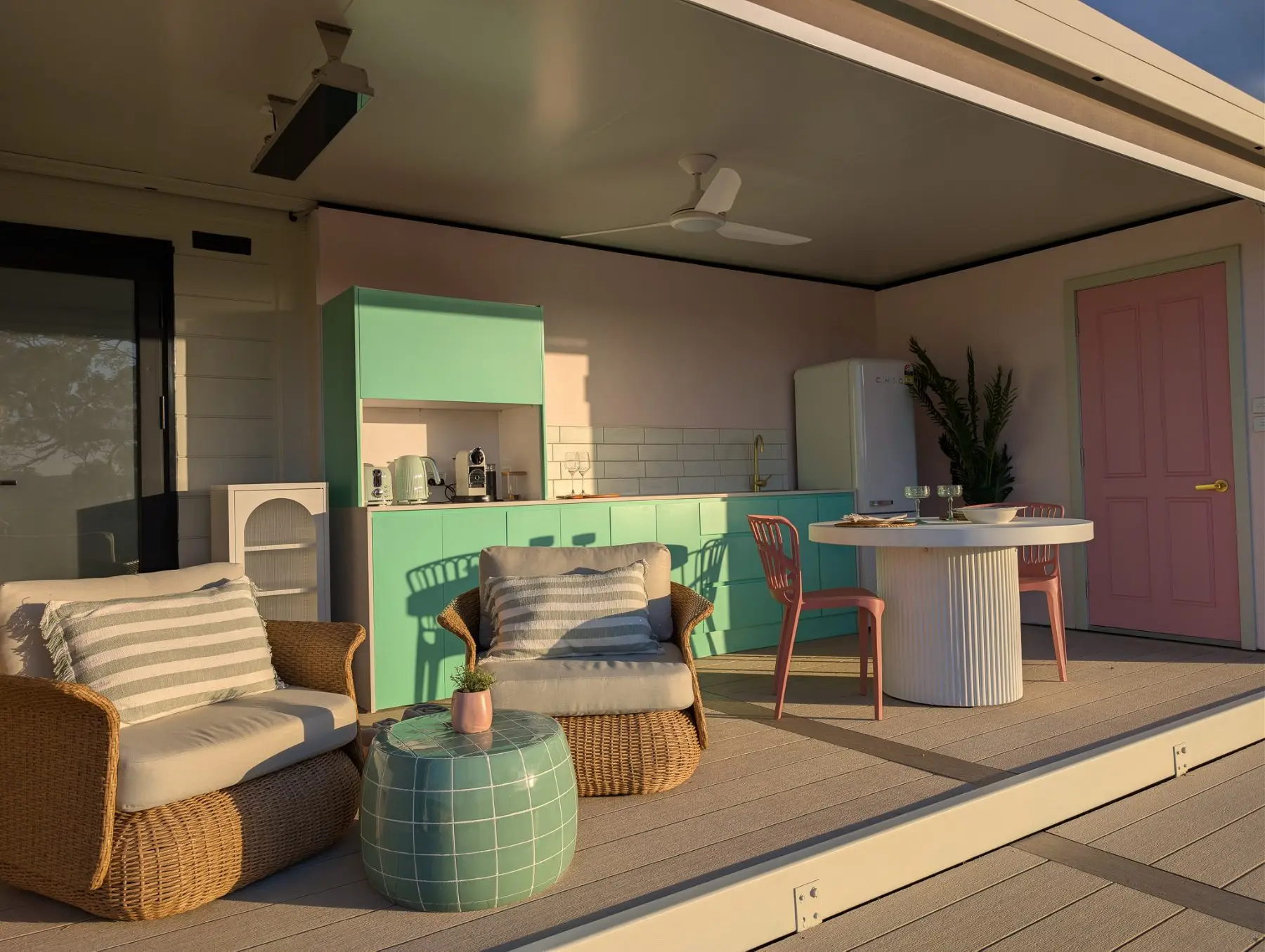 The pavilion lounge chairs and dining table in late afternoon sun