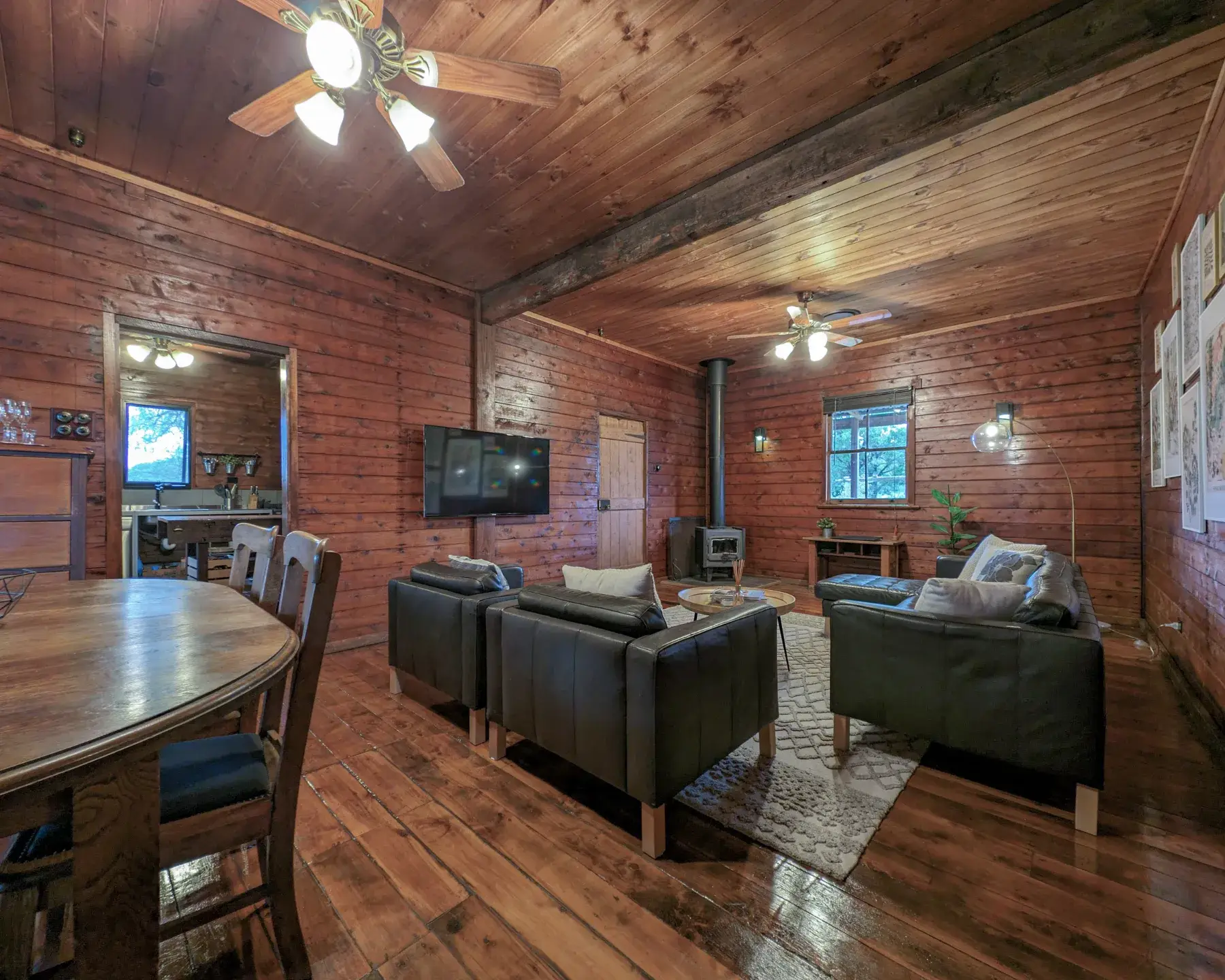 The Cottage living room, wood fire at one end and the dining table at the other