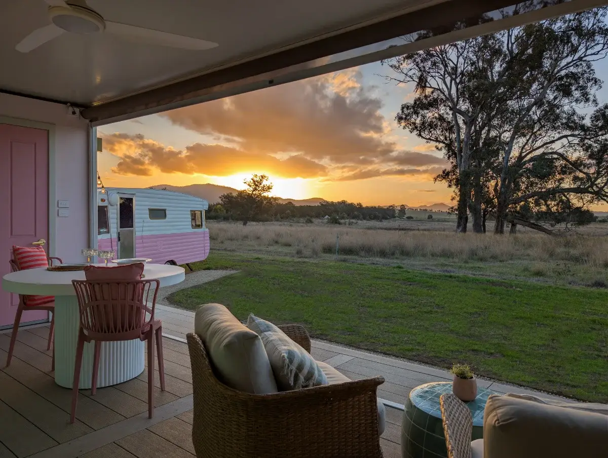 The Caravan deck at Broke Estate, with the restored pink vintage van and the ranges beyond